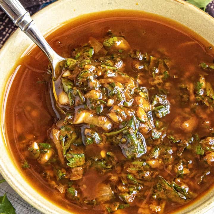 Zesty, vibrant chermoula in a bowl with a spoon