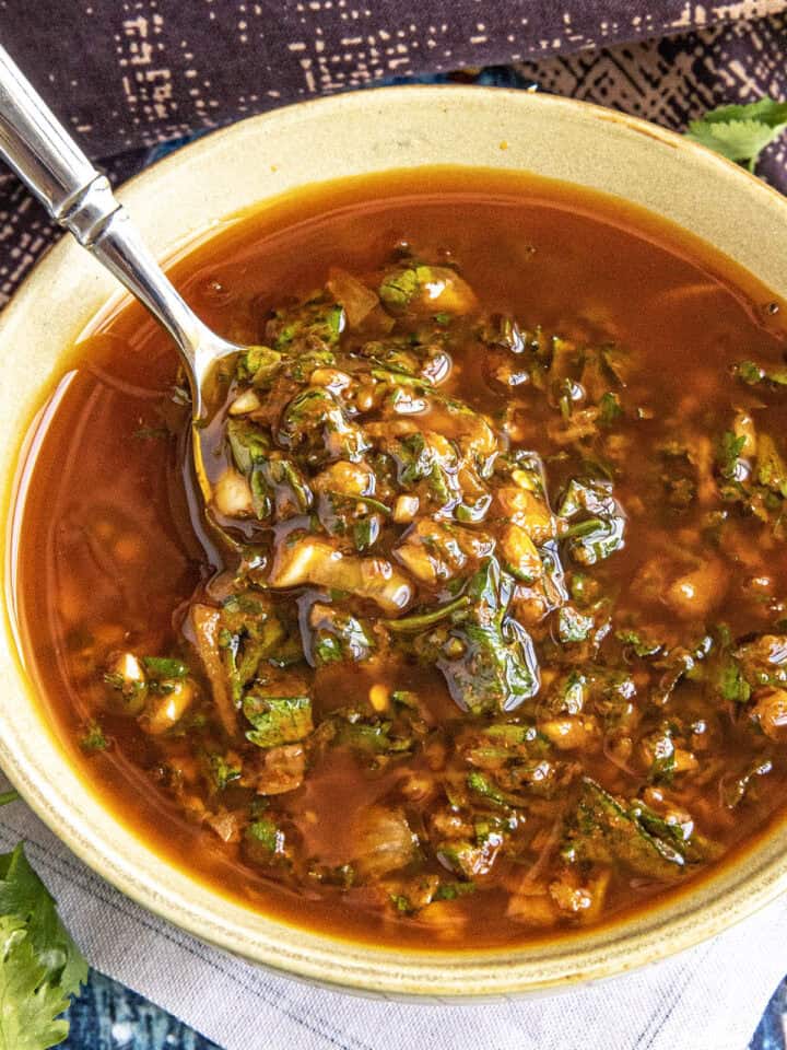 Zesty, vibrant chermoula in a bowl with a spoon