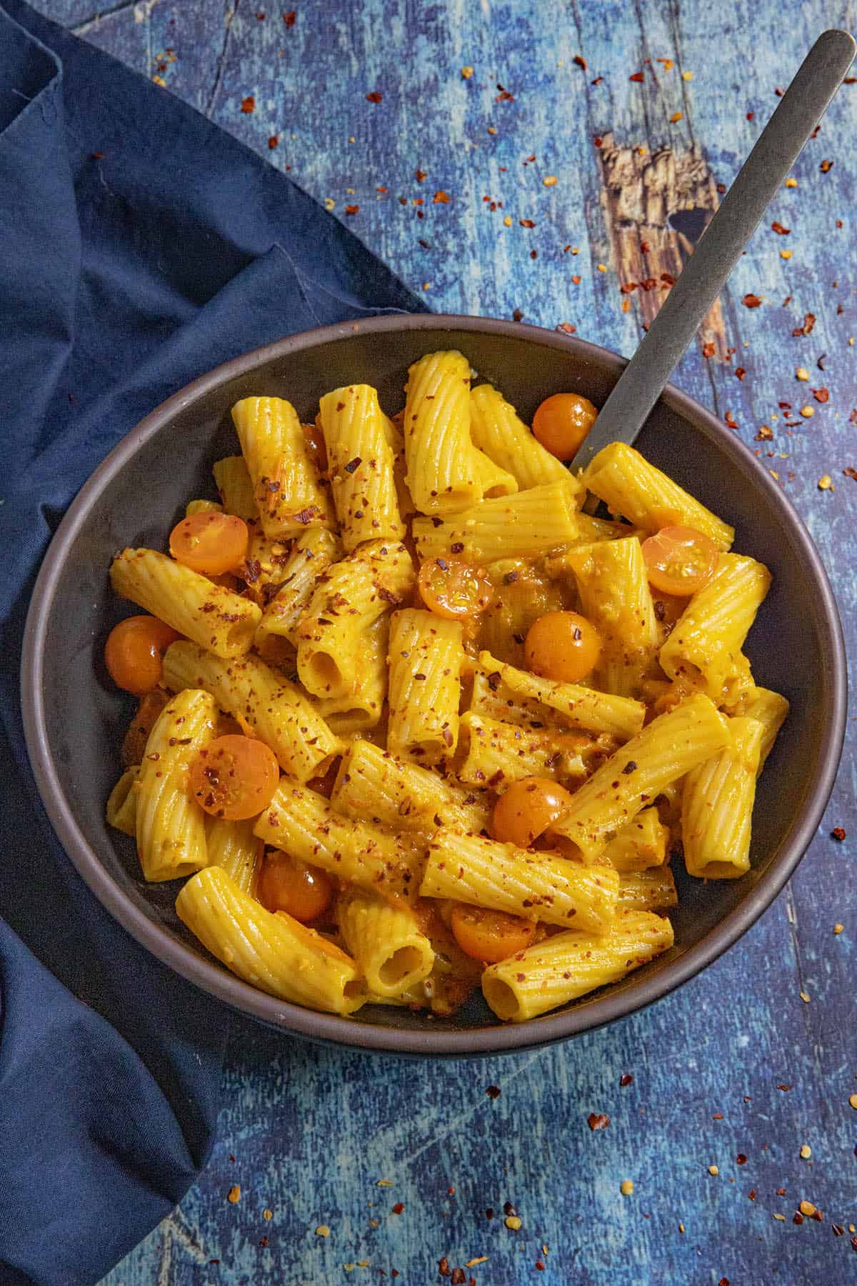 A bowl filled with penne pasta coated with Tuscan-style Cherry Tomato pasta Sauce