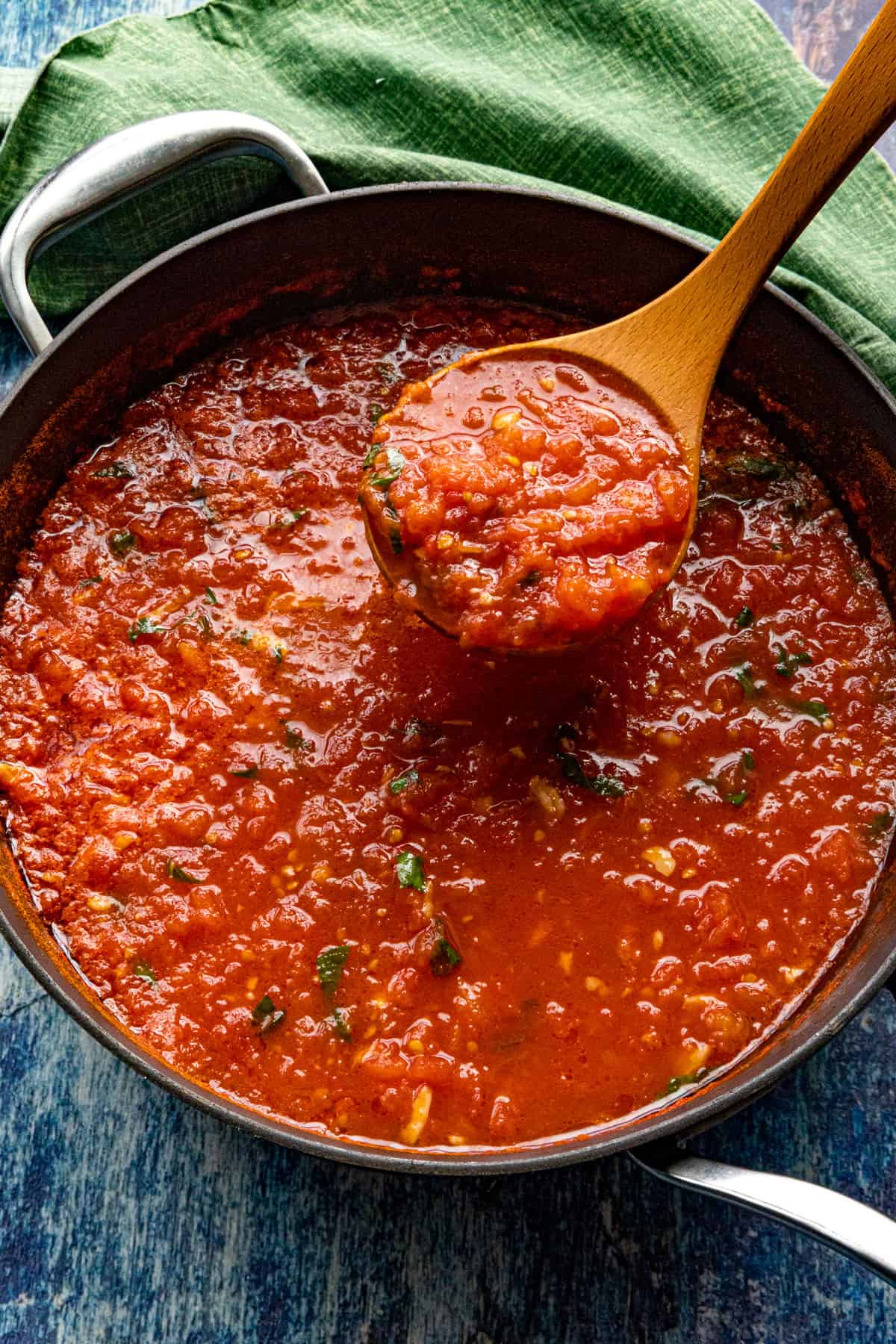 Scooping a ladle full of zesty Italian Pomodoro Sauce from the pan