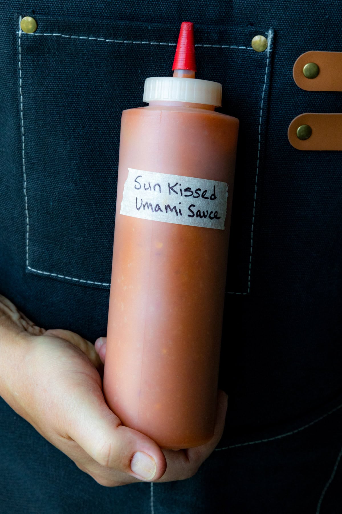 Mike holding a bottle of Sun-Kissed Umami Hot Sauce