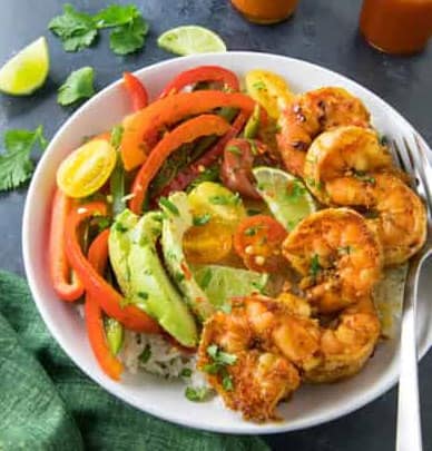 A plate full of shrimp and veggies