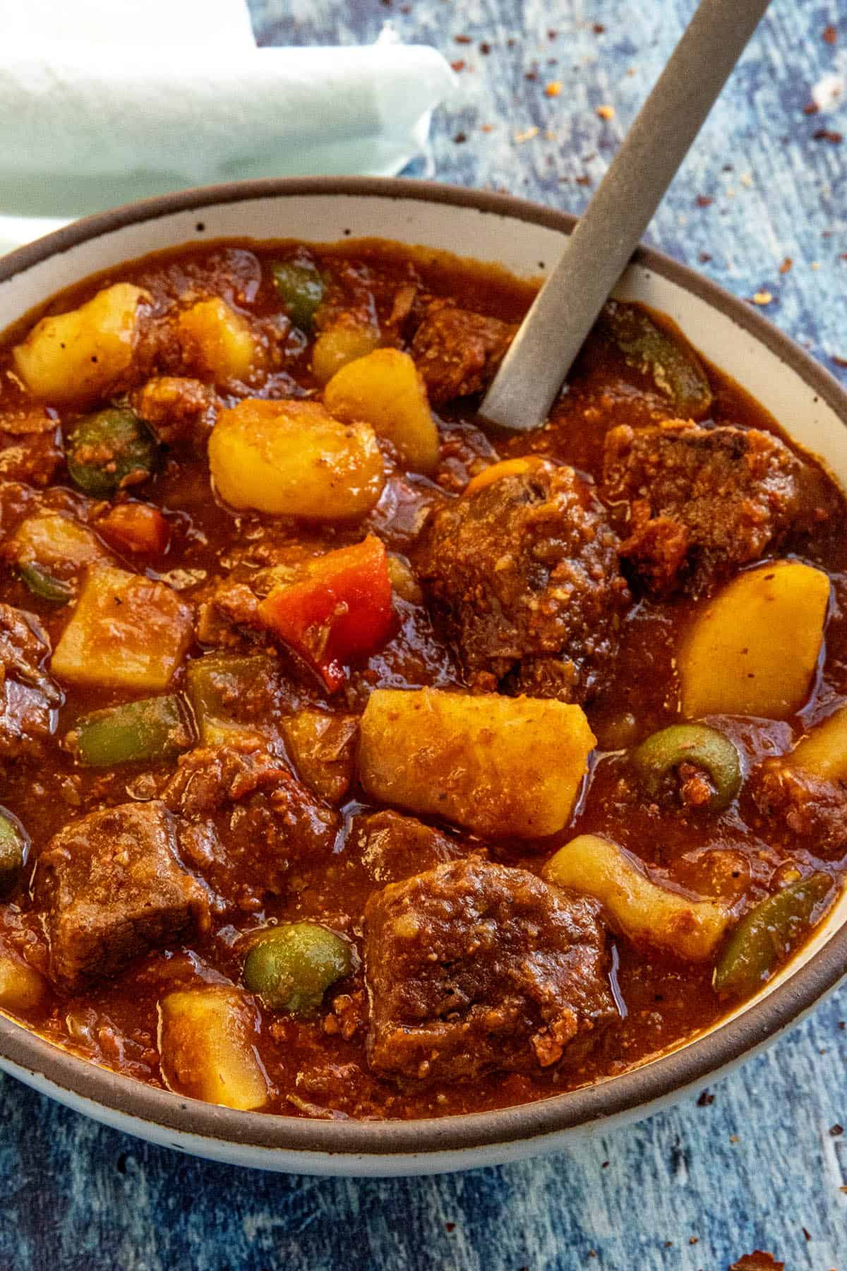 A bowl full of Beef Caldereta (Filipino Beef Stew) served with a spoon