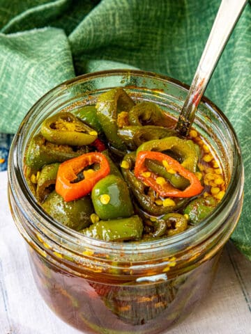 A small jar filled with sweet and spicy Candied Jalapenos (Cowboy Candy)