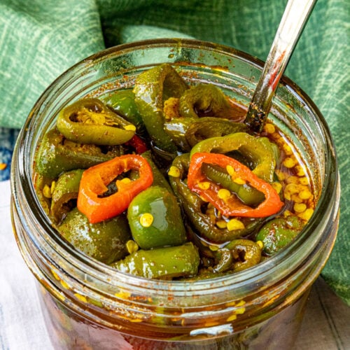 A small jar filled with sweet and spicy Candied Jalapenos (Cowboy Candy)
