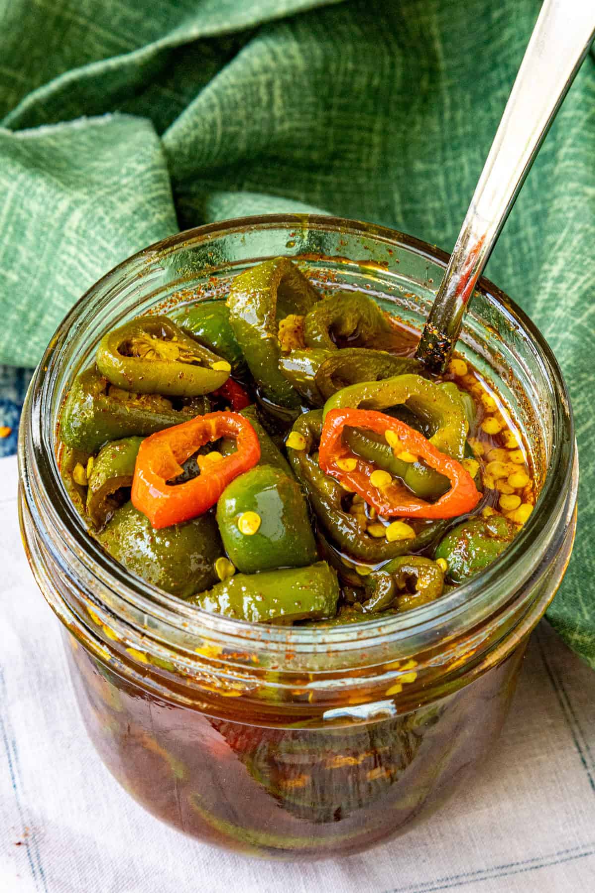 A small jar filled with sweet and spicy Candied Jalapenos (Cowboy Candy)