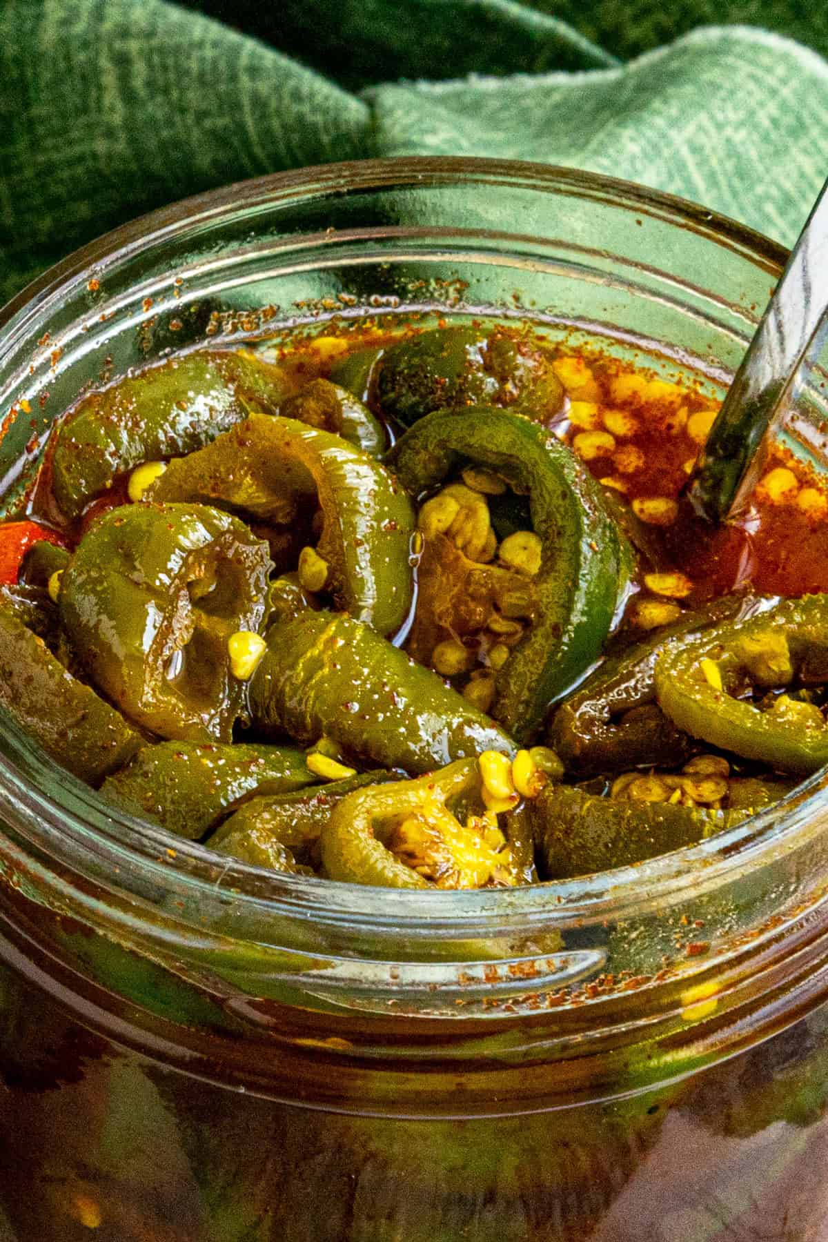 A small jar filled with Candied Jalapenos (Cowboy Candy)