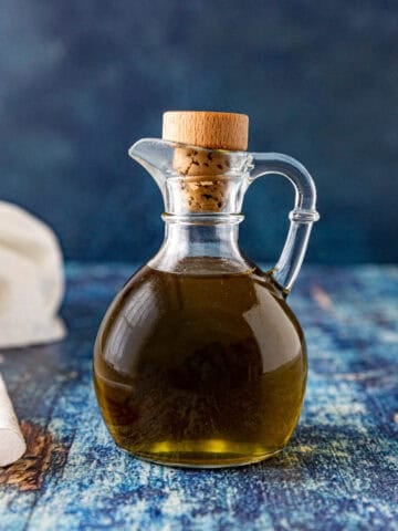 A jar filled with Homemade herb oil, ready to use