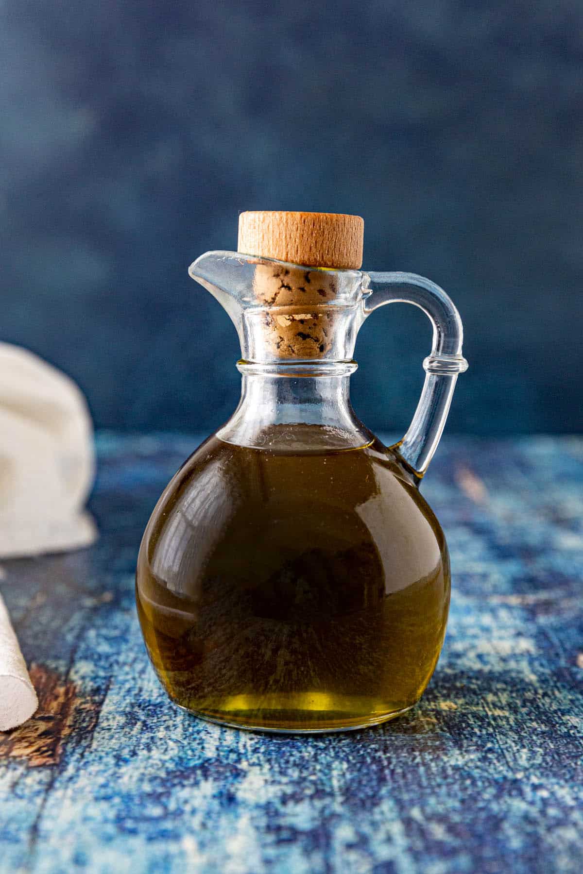 A jar filled with Homemade herb oil, ready to use