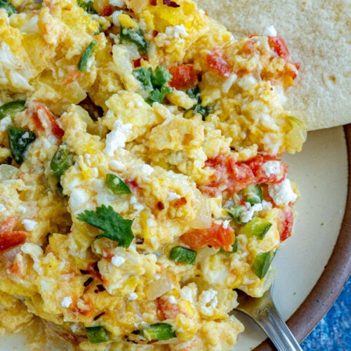 A plate of Huevos a la Mexicana served with warmed tortillas