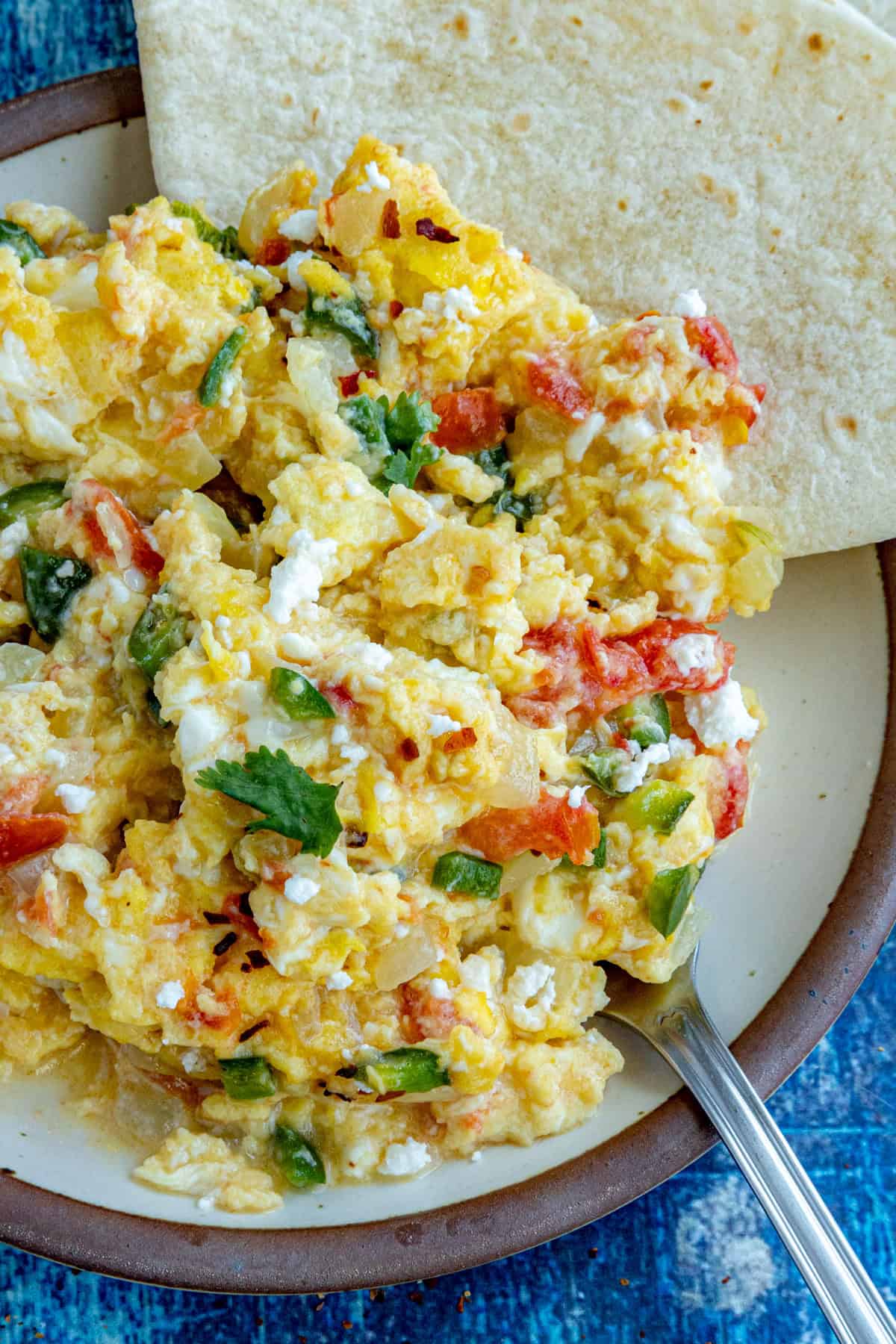 A plate of Huevos a la Mexicana served with warmed tortillas