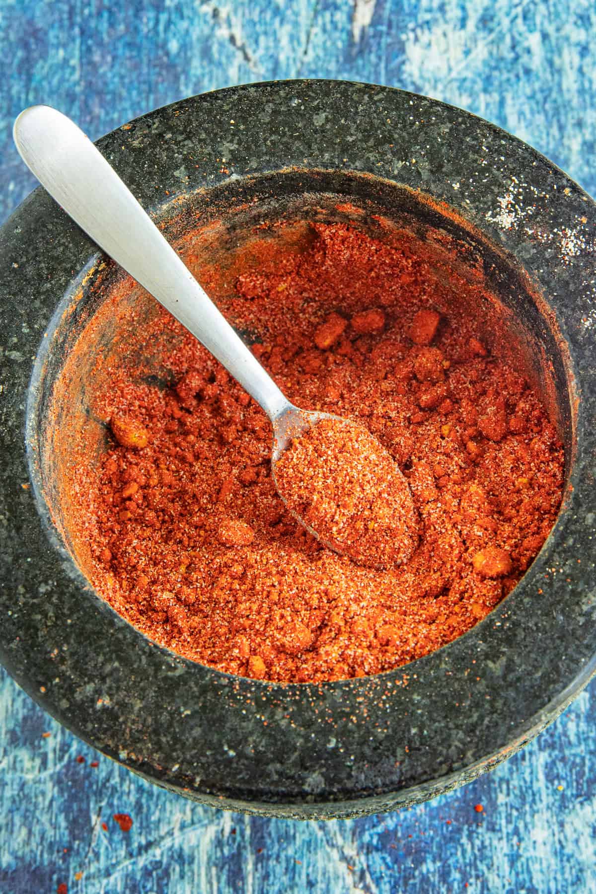 Mixing ingredients in a bowl for making Suya Spice (Yaji)