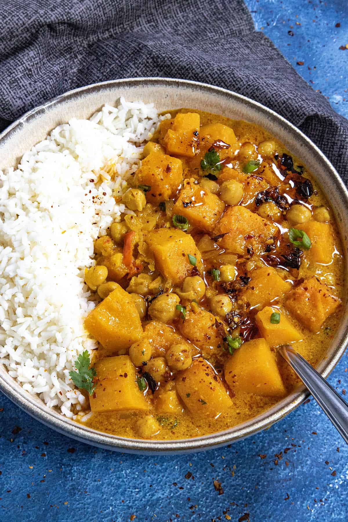 A bowl of Thai-style Butternut Squash Curry drizzled with spicy chili crisp