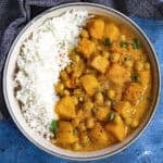 Spicy Thai-style Butternut Squash Curry with Chickpeas in a bowl with rice, ready to serve