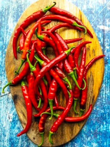 Fresh Cayenne Peppers displayed on a board