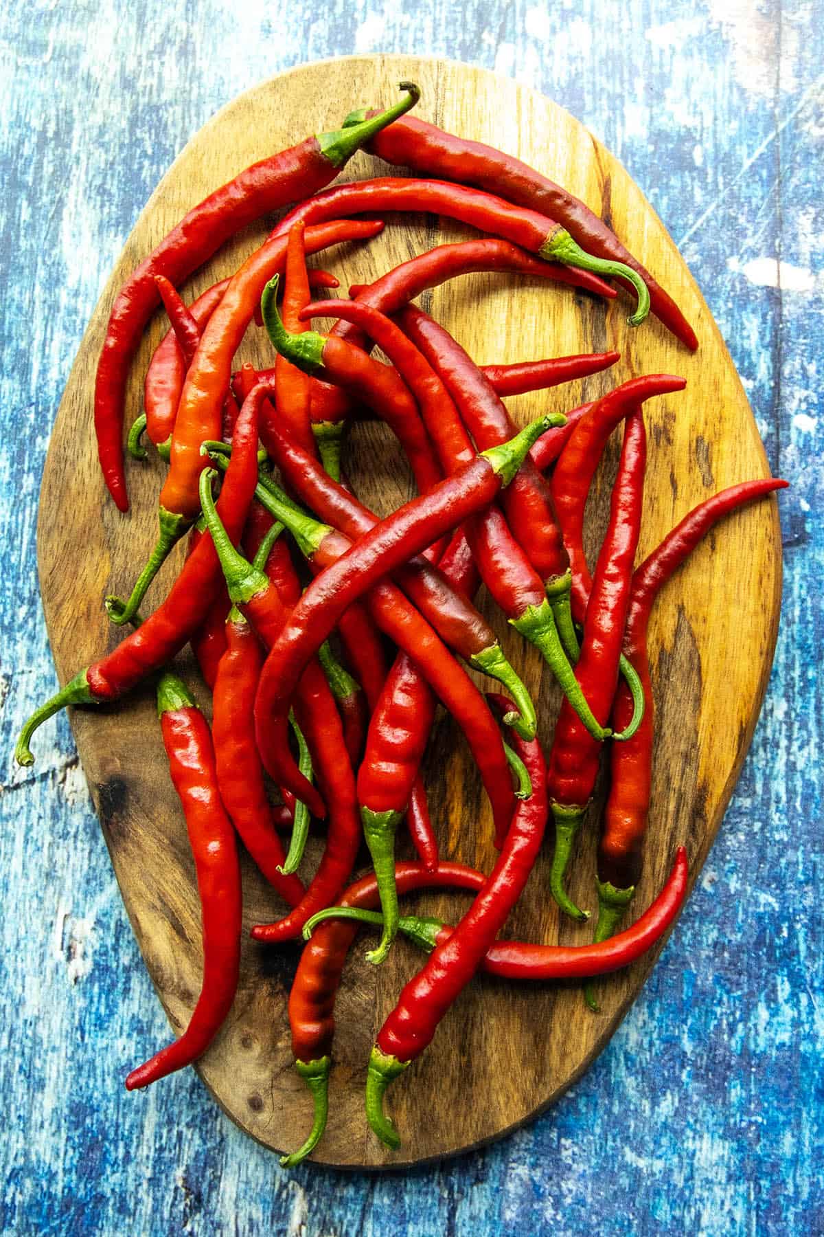 Fresh Cayenne Peppers displayed on a board