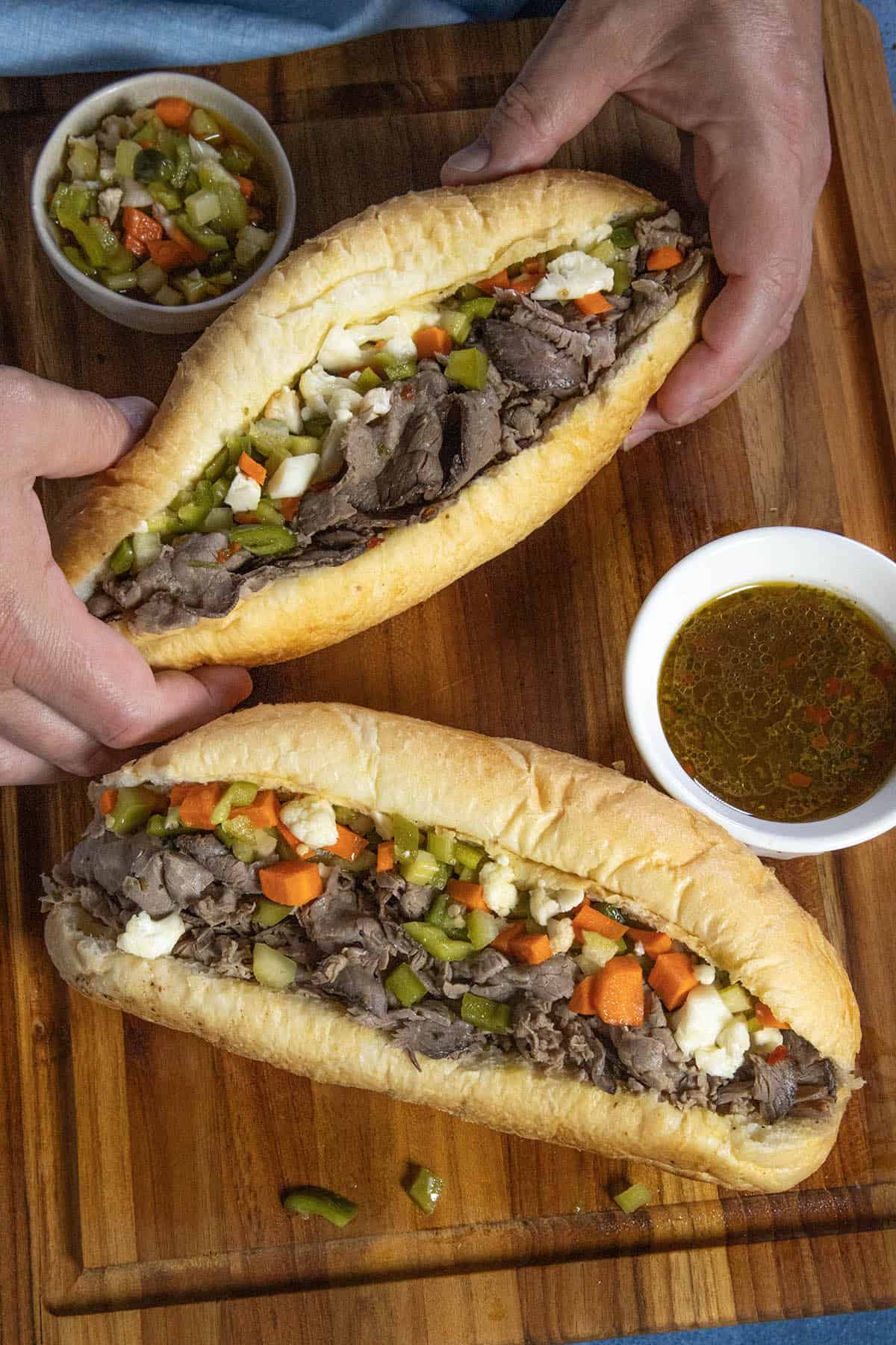 Mike grabbing an Italian beef sandwich (Chicago style) from the table