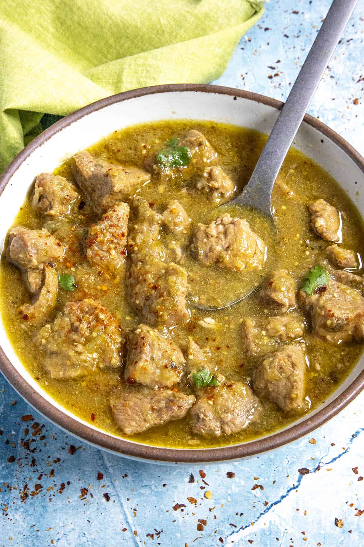 A bowl full of Chili Verde, served with garnish