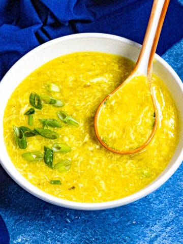 Chinese egg drop soup served in a bowl, garnished with freshly sliced green onions