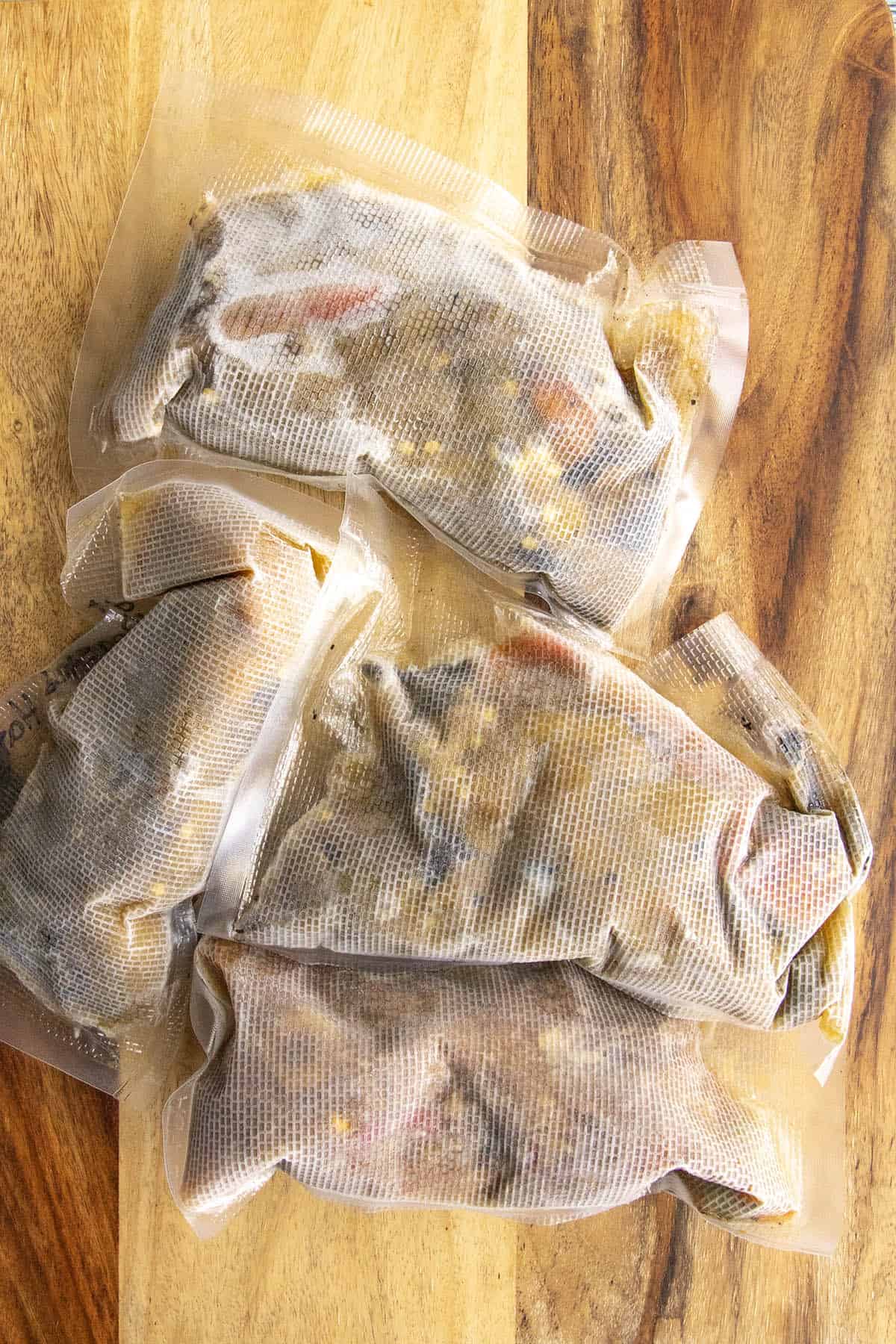 4 bags of frozen peppers on a cutting board, preserved from my garden harvest