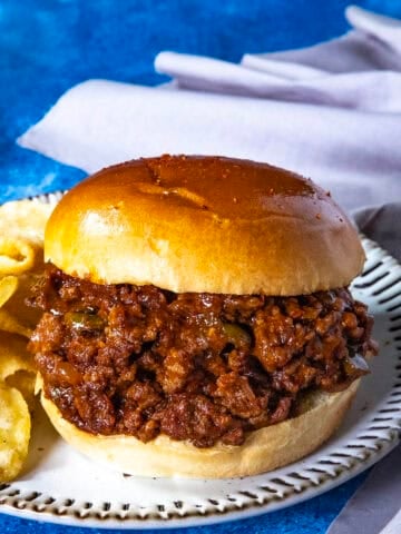 Saucy and spicy Gochujang Sloppy Joes served with potato chips on a plate