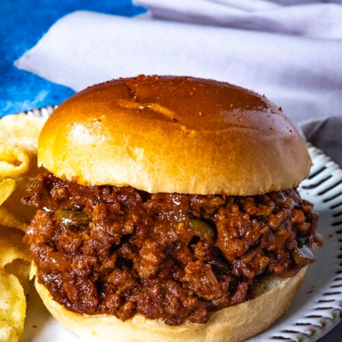 Saucy and spicy Gochujang Sloppy Joes served with potato chips on a plate