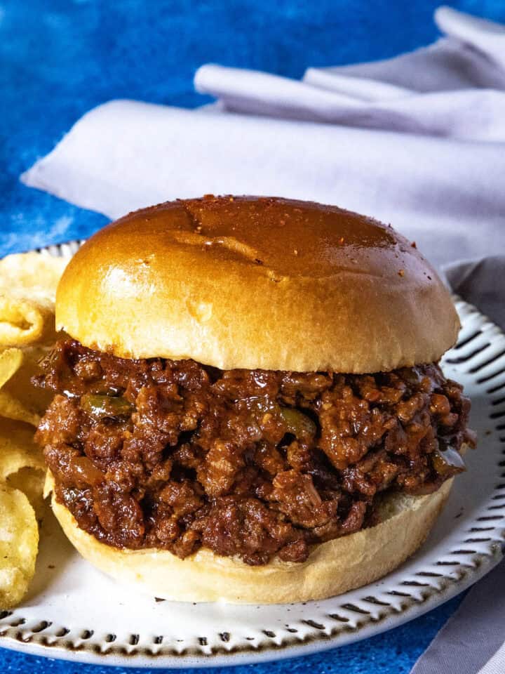 Saucy and spicy Gochujang Sloppy Joes served with potato chips on a plate