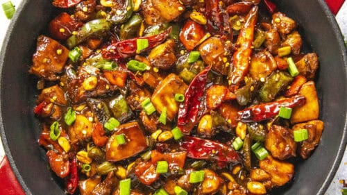 Spicy homemade Kung Pao Chicken stir fry in a pan, ready to serve, nice and hot