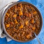 A bowl of hearty, chunky pumpkin chili, loaded with lots of pumpkin, beans, and fire roasted tomatoes