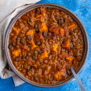 A bowl of hearty, chunky pumpkin chili, loaded with lots of pumpkin, beans, and fire roasted tomatoes