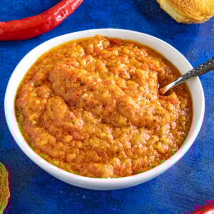Ajvar (Serbian Roasted Red Pepper Relish) in a bowl with a spoon