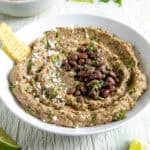 Easy Creamy Black Bean Dip in a bowl with tortilla chips