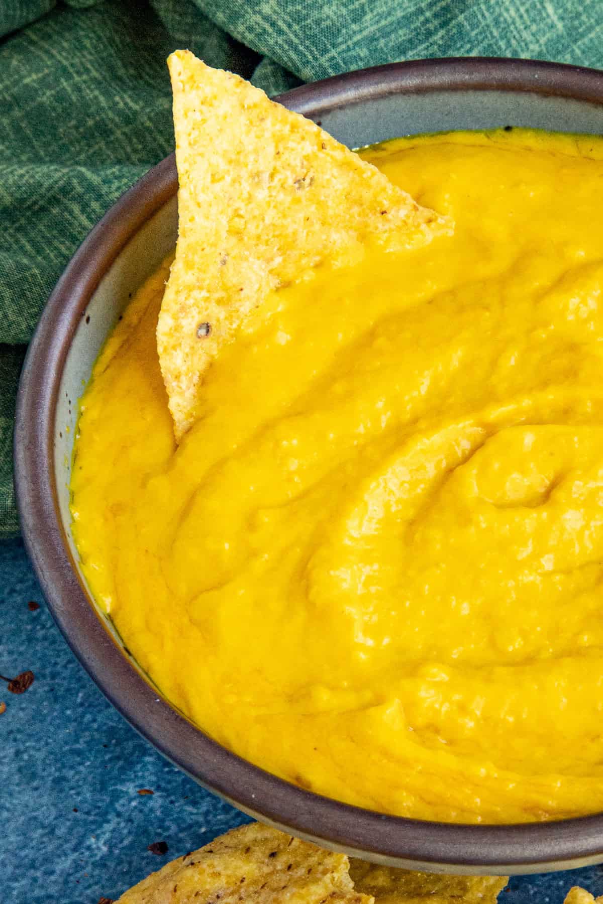 A corn tortilla chip dipped into a bowl filled with Creamy Habanero Sauce, which is thick and perfect for a salsa