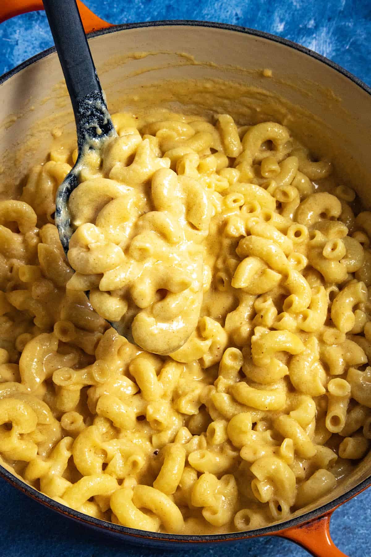 Mike serving a scoop of Creamy Macaroni and Cheese from the pot