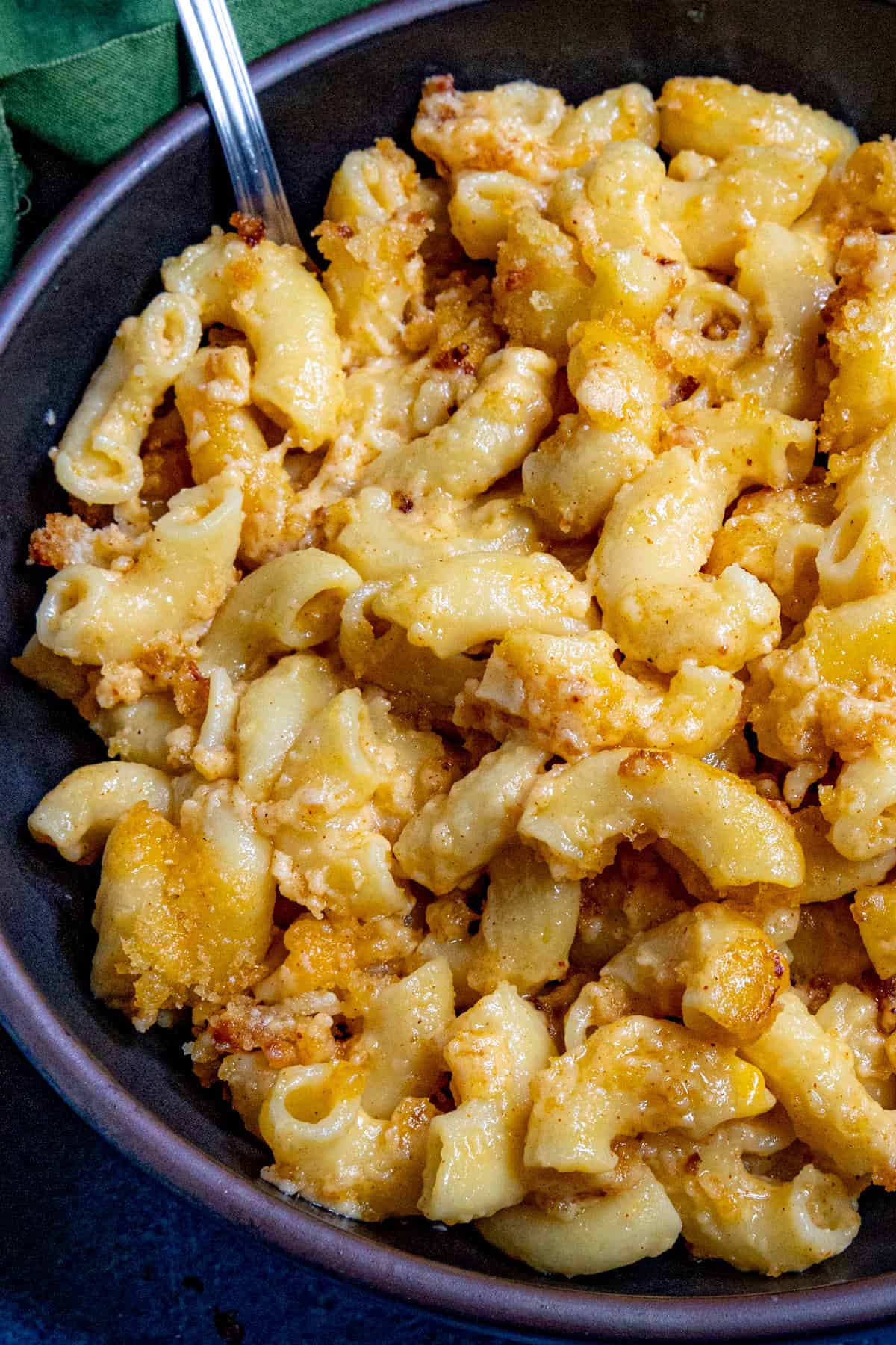 Close up of Creamy Macaroni and Cheese in a bowl, glistening with cheese