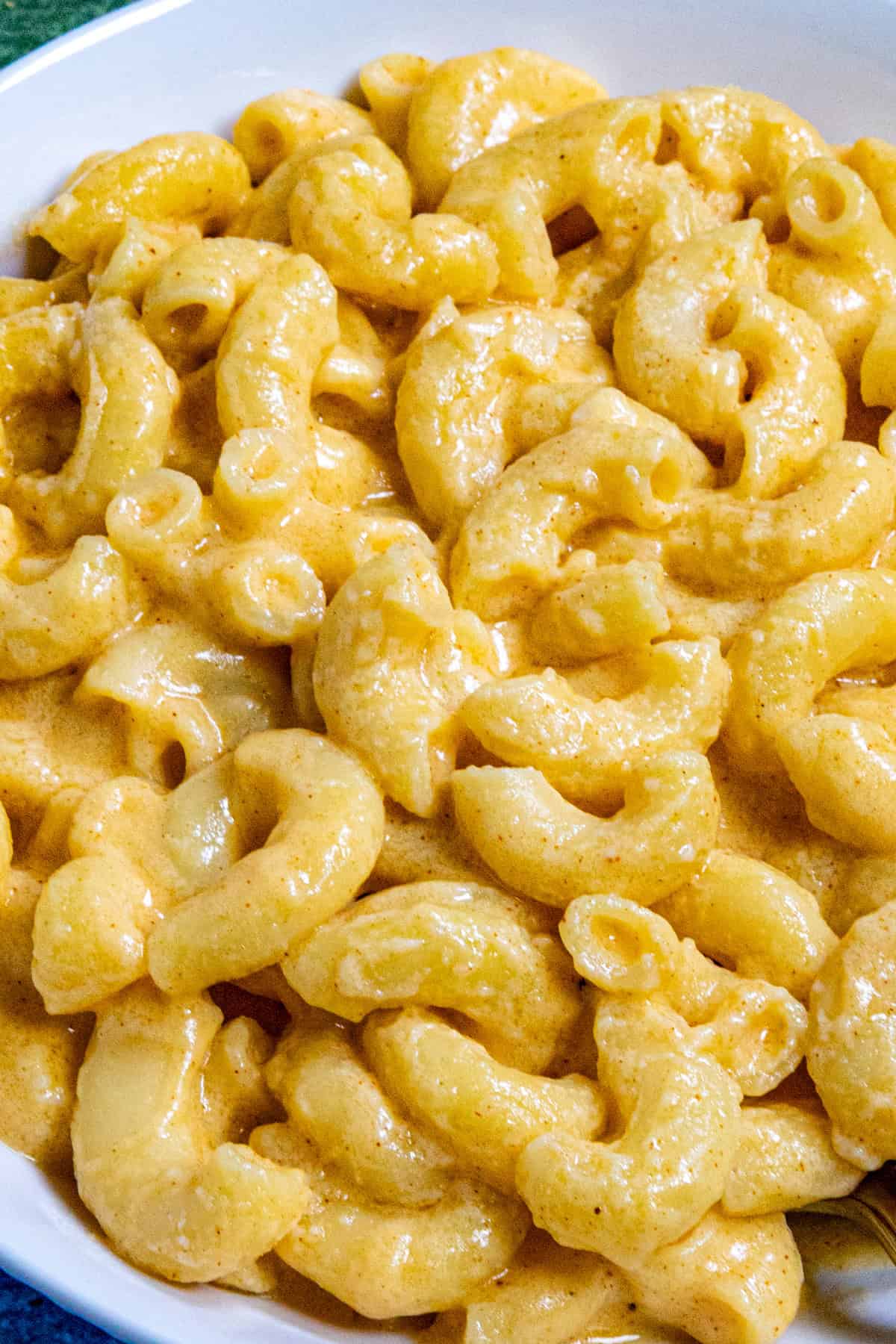 Close up of Creamy Macaroni and Cheese in a bowl to show how extra creamy and cheese you can make it