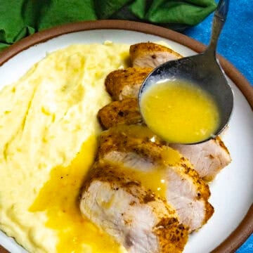 Mike ladling Roasted Garlic Gravy over sliced turkey and mashed potatoes