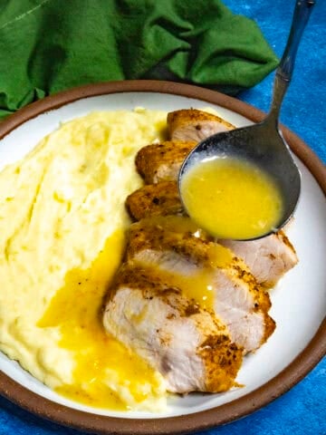 Mike ladling Roasted Garlic Gravy over sliced turkey and mashed potatoes