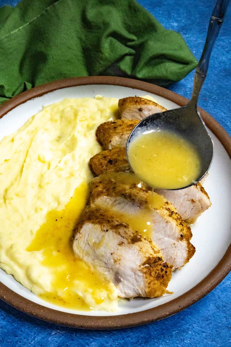 Mike ladling Roasted Garlic Gravy over sliced turkey and mashed potatoes