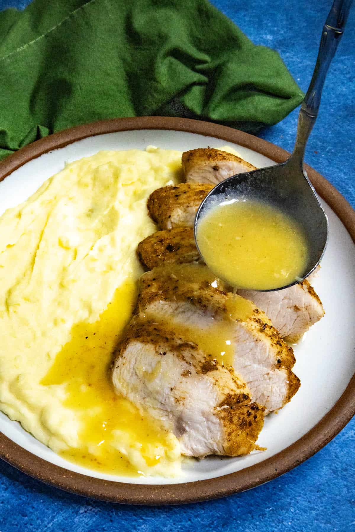 Mike ladling Roasted Garlic Gravy over sliced turkey and mashed potatoes