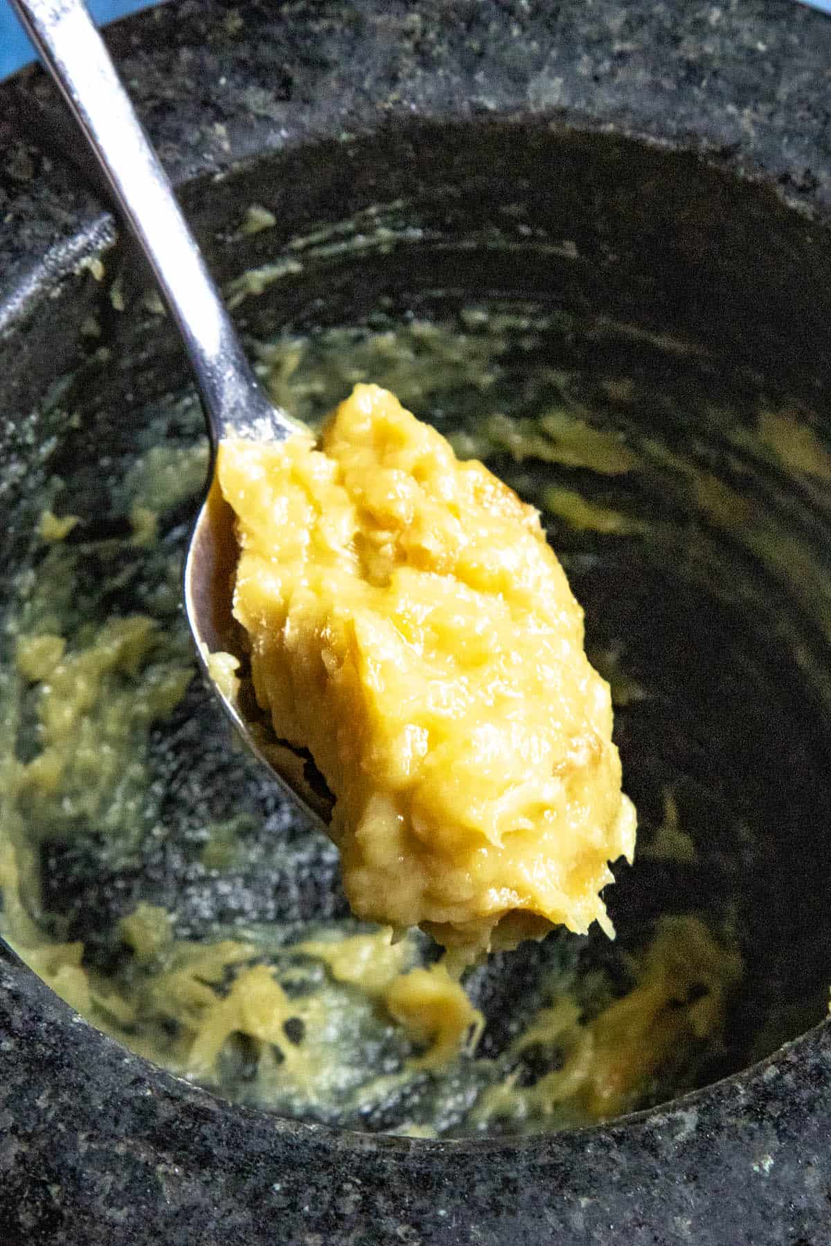 Roasted garlic paste on a spoon