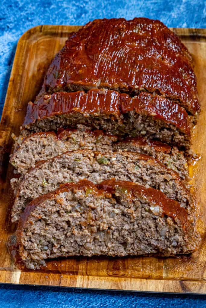 Southern style meatloaf on a cutting board, glazed and sliced, ready to serve