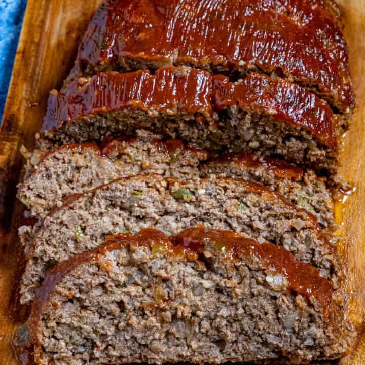 Southern style meatloaf on a cutting board, glazed and sliced, ready to serve
