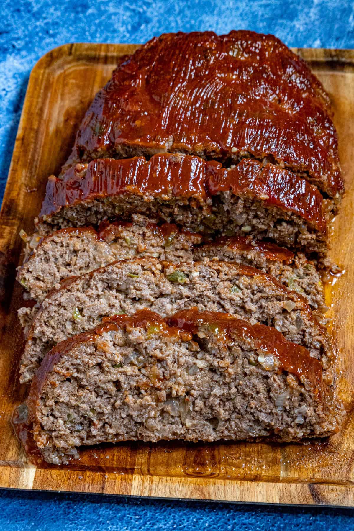 Southern style meatloaf on a cutting board, glazed and sliced, ready to serve