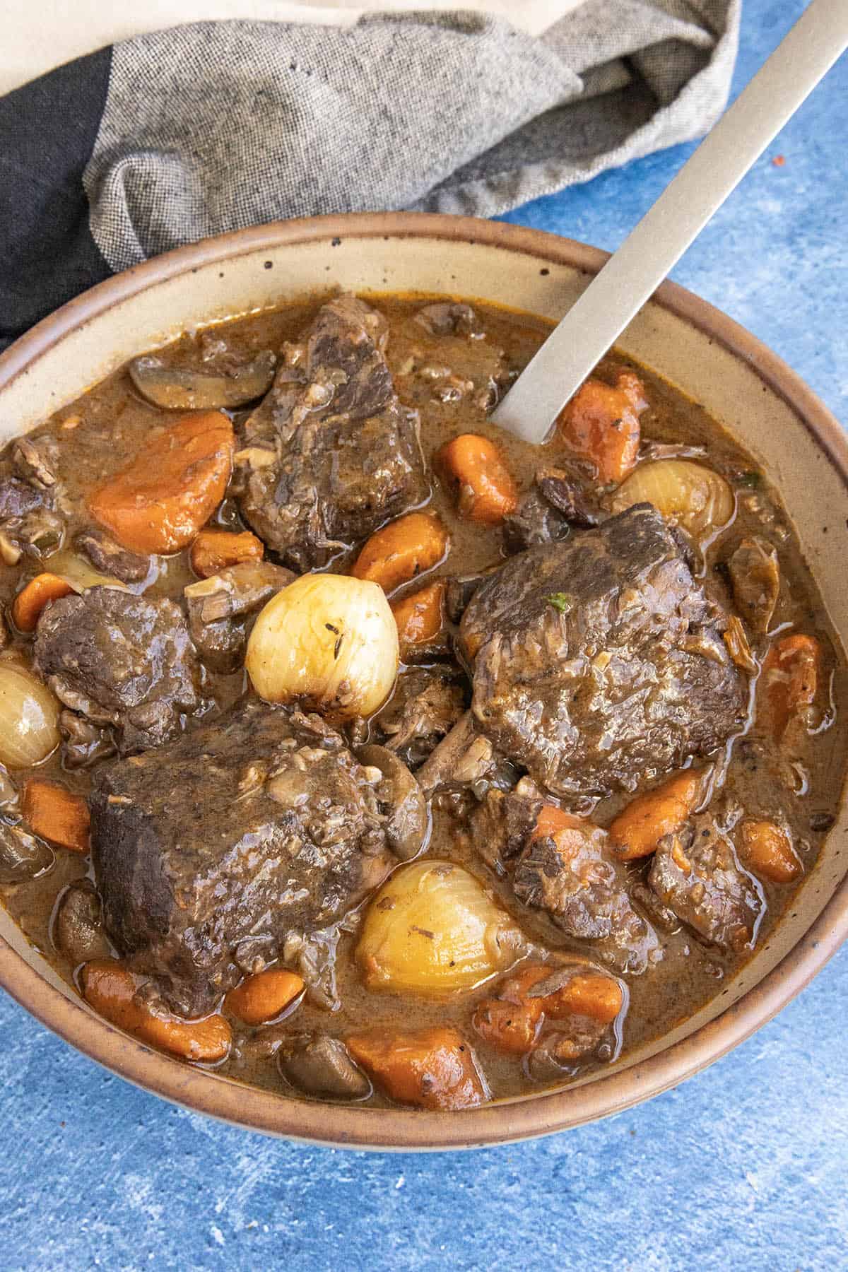 Beef Bourguignon served in a large bowl with a spoon