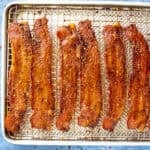 Sweet and spicy candied bacon on a baking tray, fresh out of the oven