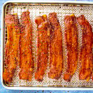 Sweet and spicy candied bacon on a baking tray, fresh out of the oven