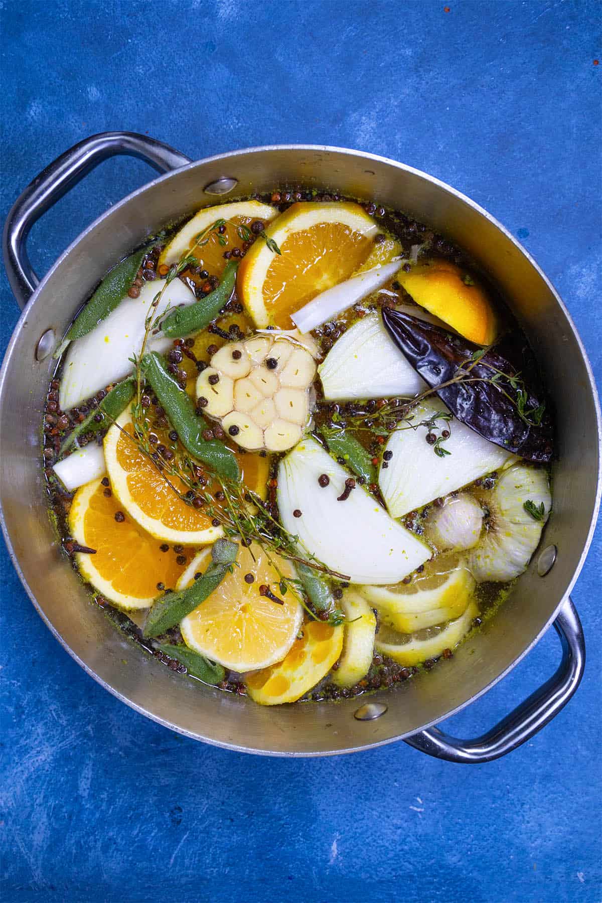 The complete set of turkey brine ingredients set into a large pot, ready for simmering