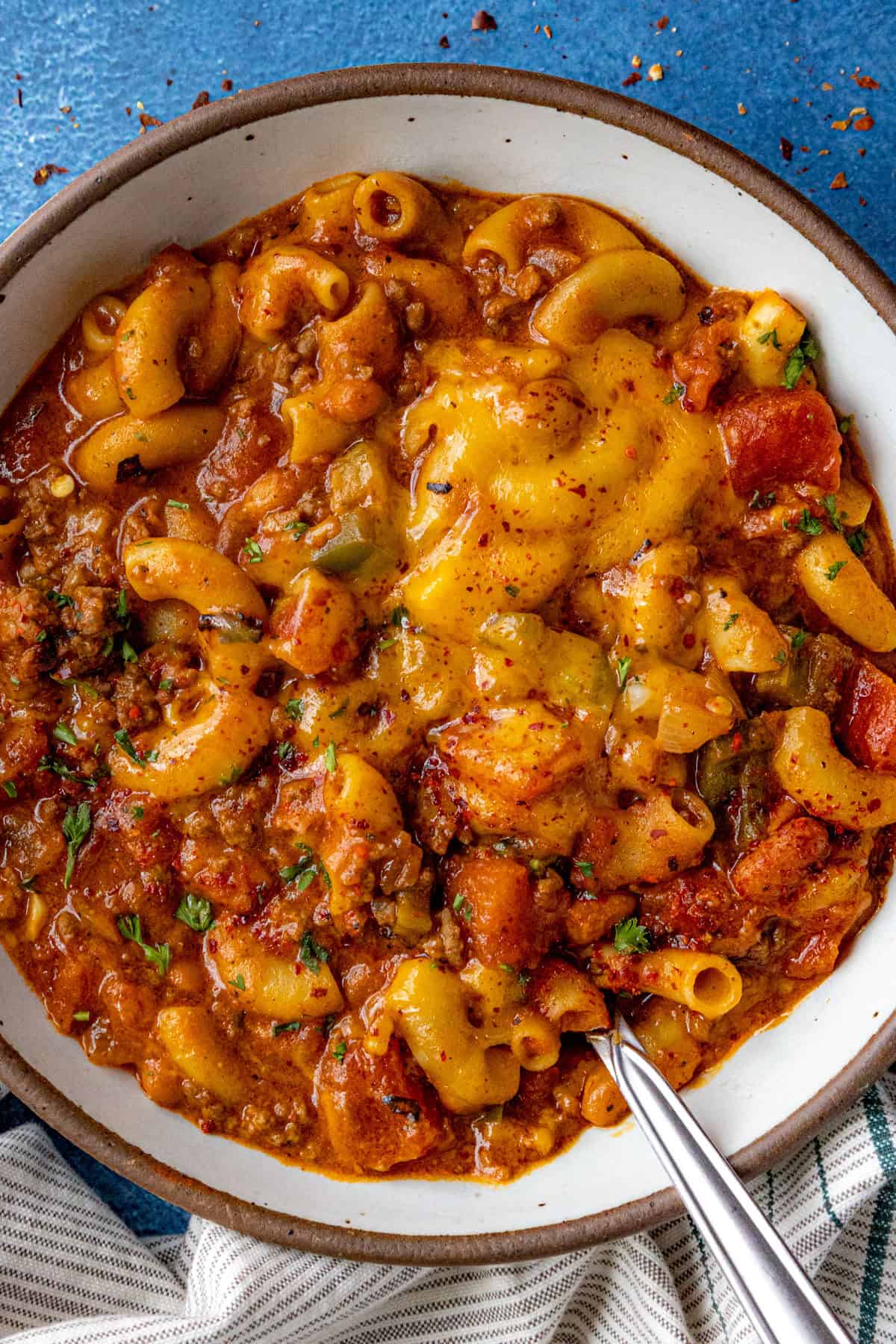 Hearty Chili Mac served in a bowl, covered with melted cheese