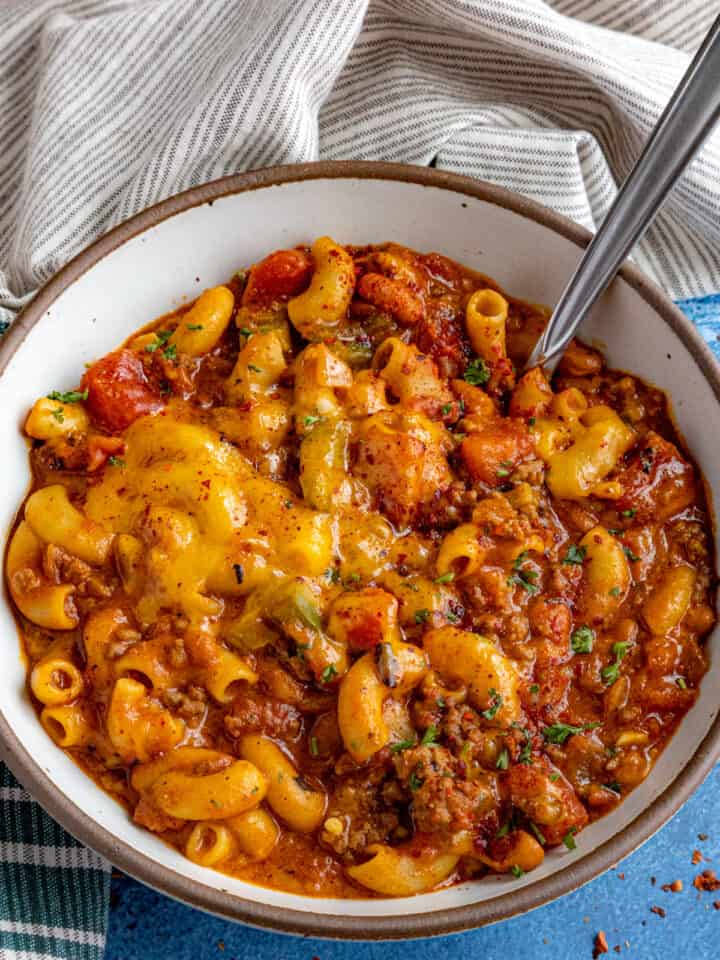 Cheesy Chili Mac in a serving bowl with a spoon